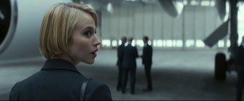 Movie still from “Black Box” (2021), directed by Yann Gozlan – A woman looking over her shoulder at a group of people; Close Up shot, Over the shoulder angle