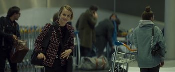 Movie still from “Black Box” (2021), directed by Yann Gozlan – A woman standing in front of a group of people; Medium shot, Over the shoulder angle