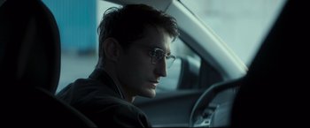 Movie still from “Black Box” (2021), directed by Yann Gozlan – A man sitting in the driver's seat of a car; Close Up shot, Over the shoulder angle