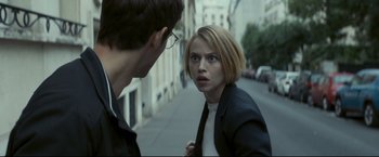 Movie still from “Black Box” (2021), directed by Yann Gozlan – A woman in black jacket looking at a man in white shirt; Close Up shot, Over the shoulder angle