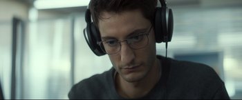 Movie still from “Black Box” (2021), directed by Yann Gozlan – A person wearing headphones; Close Up shot, Low angle