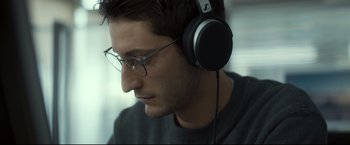 Movie still from “Black Box” (2021), directed by Yann Gozlan – A person wearing a pair of headphones; Close Up shot, Low angle