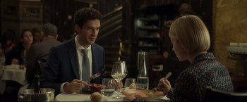 Movie still from “Black Box” (2021), directed by Yann Gozlan – A man and a woman sitting at a dinner table; Medium shot, Over the shoulder angle