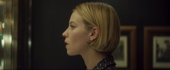 Movie still from “Black Box” (2021), directed by Yann Gozlan – A woman with blonde hair wearing a black and white shirt; Close Up shot, Over the shoulder angle