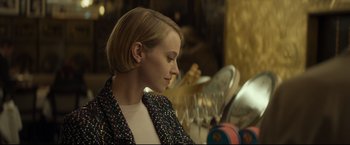 Movie still from “Black Box” (2021), directed by Yann Gozlan – A woman sitting in front of a bunch of dishes; Close Up shot, Over the shoulder angle