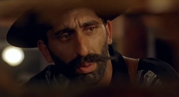 Movie still from “Black Cat, White Cat” (1998), directed by Emir Kusturica – A person with a mustache; Close Up shot, Low angle