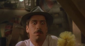 Movie still from “Black Cat, White Cat” (1998), directed by Emir Kusturica – A person wearing a hat; Close Up shot, Low angle
