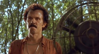 Movie still from “Black Cat, White Cat” (1998), directed by Emir Kusturica – A person with a beard and mustache; Close Up shot, Low angle