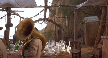 Movie still from “Black Cat, White Cat” (1998), directed by Emir Kusturica – Many geese in the middle of a field; Wide shot, Low angle