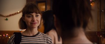 Movie still from “Black Christmas” (2019), directed by Sophia Takal – A person wearing a striped shirt; Close Up shot, Over the shoulder angle