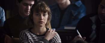 Movie still from “Black Christmas” (2019), directed by Sophia Takal – A woman in striped shirt looking at the camera; Close Up shot, Over the shoulder angle
