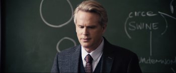 Movie still from “Black Christmas” (2019), directed by Sophia Takal – A person wearing a suit and tie; Close Up shot, Over the shoulder angle