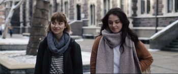 Movie still from “Black Christmas” (2019), directed by Sophia Takal – Two women walking down the street wearing scarfs; Close Up shot, Over the shoulder angle