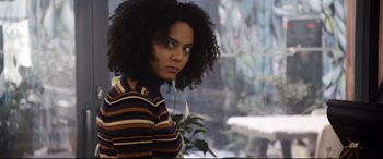 Movie still from “Black Christmas” (2019), directed by Sophia Takal – A person wearing a striped shirt; Close Up shot, Over the shoulder angle