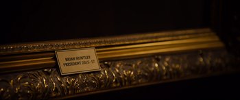 Movie still from “Black Christmas” (2019), directed by Sophia Takal – View of a plaque on a gold frame; Extreme Close Up shot, High angle