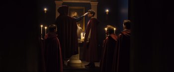 Movie still from “Black Christmas” (2019), directed by Sophia Takal – A man in a red robe standing in front of a mirror; Medium shot, Over the shoulder angle