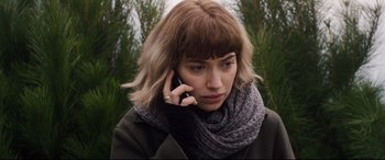 Movie still from “Black Christmas” (2019), directed by Sophia Takal – A woman in a scarf talking on a cell phone; Close Up shot, Low angle