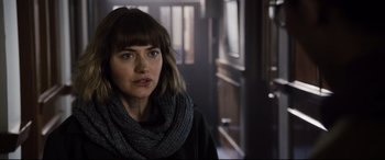 Movie still from “Black Christmas” (2019), directed by Sophia Takal – A person wearing a scarf; Close Up shot, Over the shoulder angle