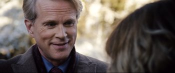 Movie still from “Black Christmas” (2019), directed by Sophia Takal – A person wearing a suit and tie; Close Up shot, Over the shoulder angle