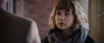 Movie still from “Black Christmas” (2019), directed by Sophia Takal – A person wearing a scarf; Close Up shot, Over the shoulder angle