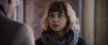 Movie still from “Black Christmas” (2019), directed by Sophia Takal – A person wearing a scarf; Close Up shot, Over the shoulder angle
