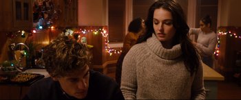 Movie still from “Black Christmas” (2019), directed by Sophia Takal – Two people in a room with lights in the background; Medium shot, Over the shoulder angle