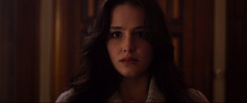Movie still from “Black Christmas” (2019), directed by Sophia Takal – A person with long brown hair; Close Up shot, Over the shoulder angle
