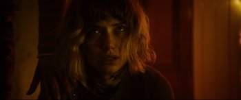 Movie still from “Black Christmas” (2019), directed by Sophia Takal – A woman with blonde curly hair stares into the camera; Close Up shot, Low angle