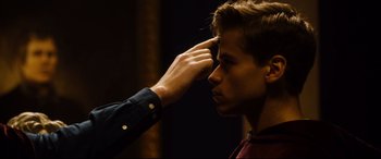 Movie still from “Black Christmas” (2019), directed by Sophia Takal – A man touching the forehead of another man; Close Up shot, Over the shoulder angle