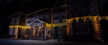 Movie still from “Black Christmas” (2019), directed by Sophia Takal – A building with a lot of christmas lights on it; Extreme Wide shot, Low angle