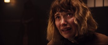 Movie still from “Black Christmas” (2019), directed by Sophia Takal – A person with a crying face; Close Up shot, Low angle