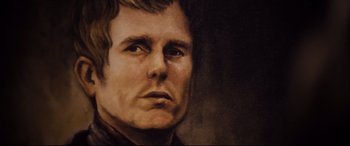 Movie still from “Black Christmas” (2019), directed by Sophia Takal – A painting of a man in a black shirt looking to his left; Extreme Close Up shot, Low angle