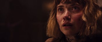 Movie still from “Black Christmas” (2019), directed by Sophia Takal – A person's face in a dark room; Close Up shot, Low angle