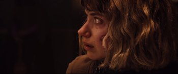 Movie still from “Black Christmas” (2019), directed by Sophia Takal – A person looking down at the ground; Close Up shot, Over the shoulder angle