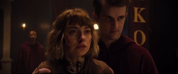 Movie still from “Black Christmas” (2019), directed by Sophia Takal – A man and a woman standing next to each other in the dark; Close Up shot, Over the shoulder angle