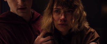 Movie still from “Black Christmas” (2019), directed by Sophia Takal – A person holding a hand on his shoulder; Close Up shot, Low angle
