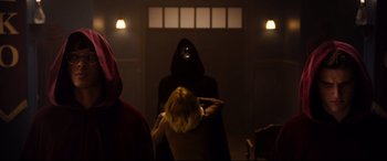 Movie still from “Black Christmas” (2019), directed by Sophia Takal – A person in a dark room holding a rope; Medium shot, Low angle