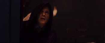 Movie still from “Black Christmas” (2019), directed by Sophia Takal – A man wearing a robe and a tie in a dark room; Close Up shot, Over the shoulder angle