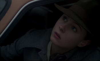 Movie still from “Black Moon” (1975), directed by Louis Malle – A woman in a hat sitting in the back of a car; Close Up shot, Low angle
