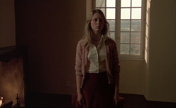 Movie still from “Black Moon” (1975), directed by Louis Malle – A woman standing in front of an open window; Medium shot, Low angle