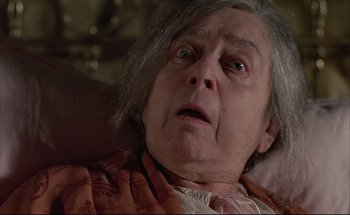 Movie still from “Black Moon” (1975), directed by Louis Malle – An old woman with grey hair looking surprised; Close Up shot, High angle