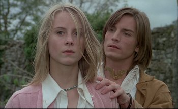 Movie still from “Black Moon” (1975), directed by Louis Malle – A man and a woman standing next to each other; Close Up shot, Low angle