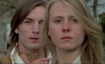 Movie still from “Black Moon” (1975), directed by Louis Malle – A man and a woman posing for a picture; Close Up shot, Low angle