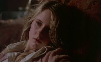 Movie still from “Black Moon” (1975), directed by Louis Malle – A woman with long blonde hair laying on a couch; Close Up shot, High angle