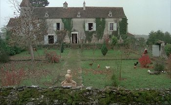 Movie still from “Black Moon” (1975), directed by Louis Malle – An old farm house with chickens in the yard; Extreme Wide shot, High angle