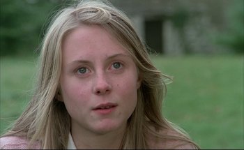 Movie still from “Black Moon” (1975), directed by Louis Malle – A person with long blonde hair; Close Up shot, Over the shoulder angle