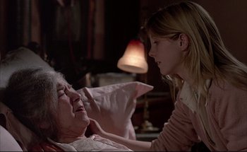 Movie still from “Black Moon” (1975), directed by Louis Malle – An older woman laying in bed with a young girl; Close Up shot, Over the shoulder angle