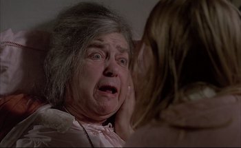 Movie still from “Black Moon” (1975), directed by Louis Malle – An older woman is crying in front of a young girl; Close Up shot, Over the shoulder angle