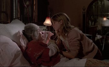 Movie still from “Black Moon” (1975), directed by Louis Malle – An older woman laying in bed with a younger woman; Medium shot, Over the shoulder angle