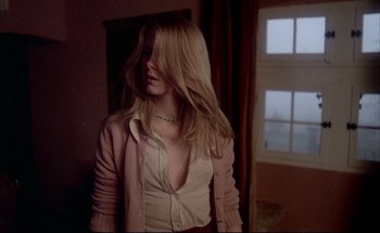 Movie still from “Black Moon” (1975), directed by Louis Malle – A woman with long blonde hair standing in front of a window; Medium shot, Low angle
